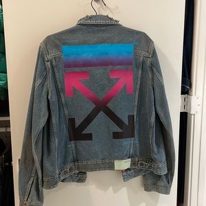 Mens blue vintage wash off white jean jacket. Multicolor logo on the back